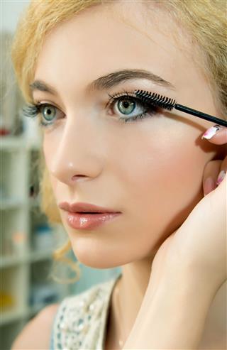 Artist Applying Mascara On Models