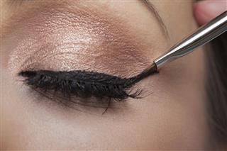 Woman Applying Eyeliner