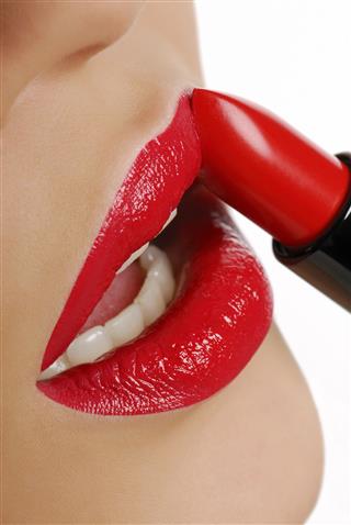 Woman Applying Red Lipstick