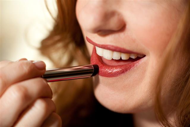 Woman Applying Lipstick