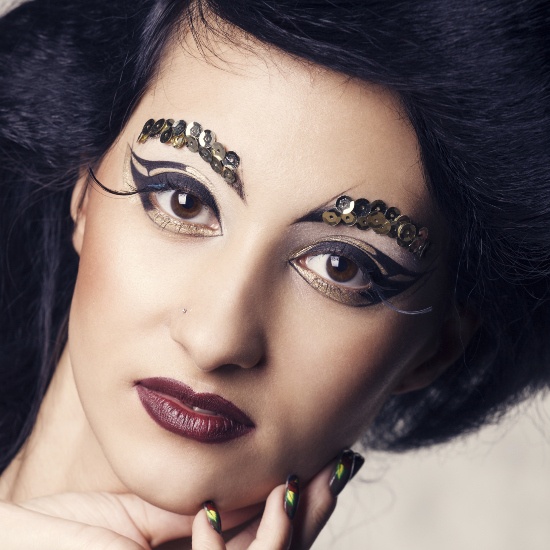 Avant-garde Eye Makeup with Black and Gold Eyeshadow and Sequin