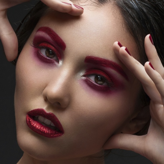 Avant-garde Eye Makeup with Red Eyeshadow and Eyebrows